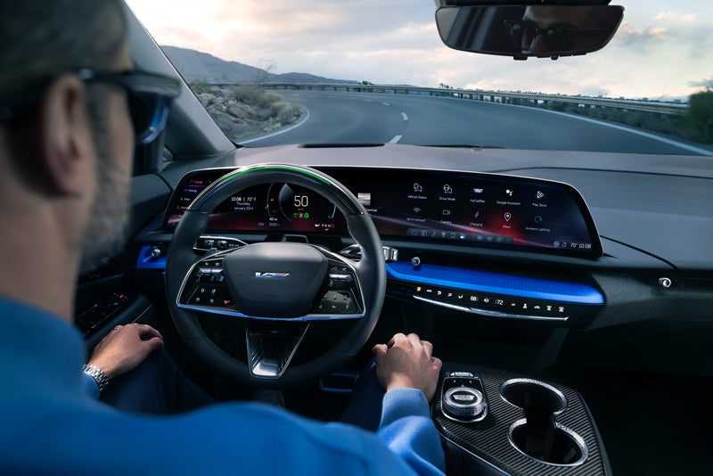 Front View of the 2026 OPTIQ-V Driving Through the Dusk Utilizing its Headlights | Burke Cadillac in Cape May Court House NJ